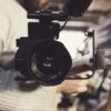 closeup photo of person carrying professional video recorder